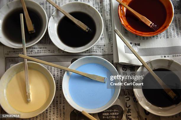 Dyes for colouring patterns on kimono fabric are placed on a shelf at the Sensyo Ichikawa kimono workshop on April 26, 2016 in Kyoto, Japan. The...