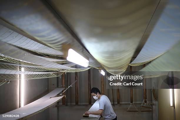 Fabric dye master applies dye to kimono fabric during a stage of its production process at the Sensyo Ichikawa kimono workshop on April 26, 2016 in...