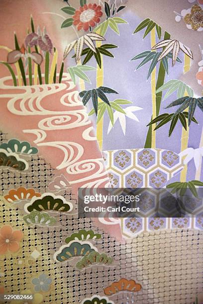 Kimono fabric is displayed after being pressed flat following the painting and dyeing process where it is often creased, during a stage of its...