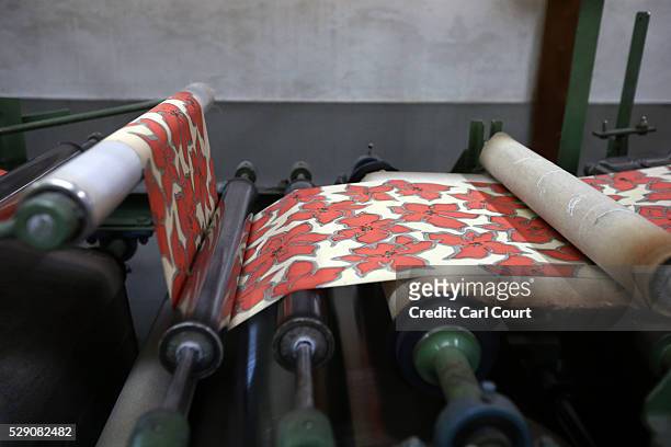 Kimono fabric is pressed flat after the painting and dyeing process where it is often creased, during a stage of its production process at the Sensyo...