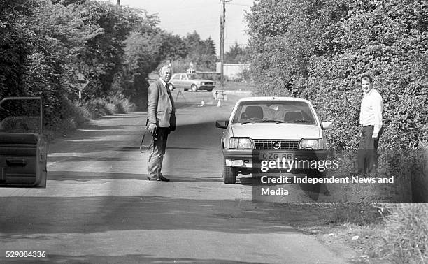 Gardai examine one of the getaway cars abandoned on the Ashbourne road outside Dunshaughlin which was used in the raid on the Drumree, Co Meath Post...