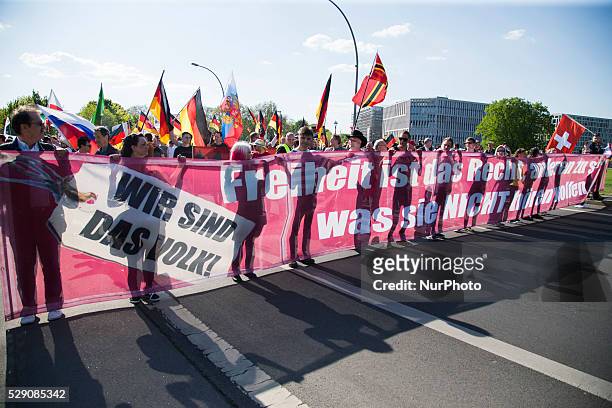 Right-wing activists march in the city center during a demonstration organised under the motto 'Merkel must go' to protest against German Chancellor...