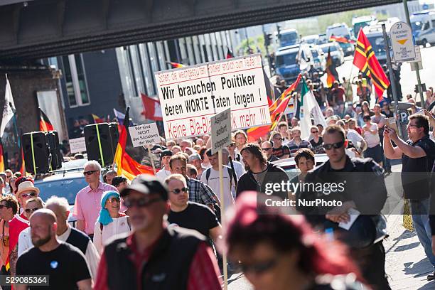 Right-wing activists and Neo-Nazis march in the city center during a demonstration organised under the motto 'Merkel must go' to protest against...