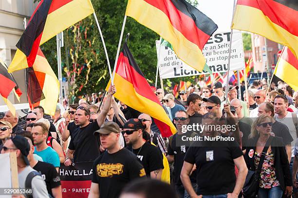 Right-wing activists and Neo-Nazis march in the city center during a demonstration organised under the motto 'Merkel must go' to protest against...