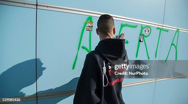 Right-wing activist attach steakers on a wall during a march organised under the motto 'Merkel must go' to protest against German Chancellor Angela...