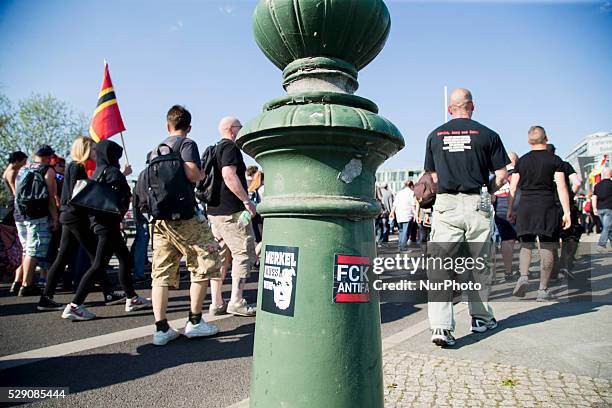 Right-wing steakers are pictured attached on a lamp post while a march organised under the motto 'Merkel must go' to protest against German...