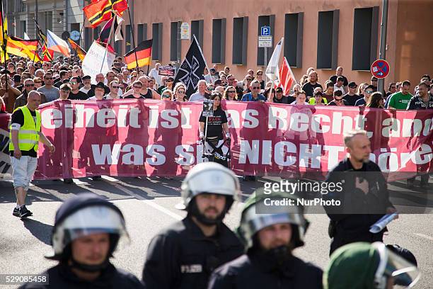 Right-wing activists and neo-nazis march in the city center during a demonstration organised under the motto 'Merkel must go' to protest against...