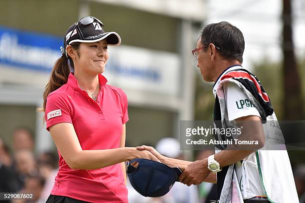 Ayaka Watanabe of Japan shakes hand with her caddie on the 18th hole during the World Ladies Championship Salonpas Cup at the Ibaraki Golf Club on...