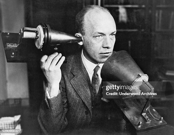 Man using one of Alexander Graham Bell's first telephones, circa 1915.