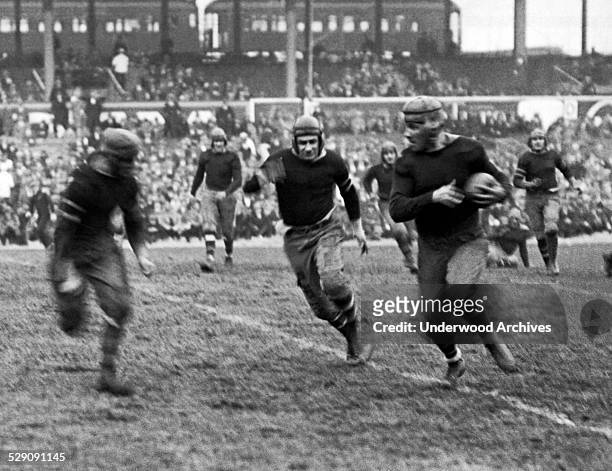 New York Giants rookie running back Heinie Benkert from Rutgers about to be tackled after a 30 yard run in a game against the Rochester Jeffersons,...