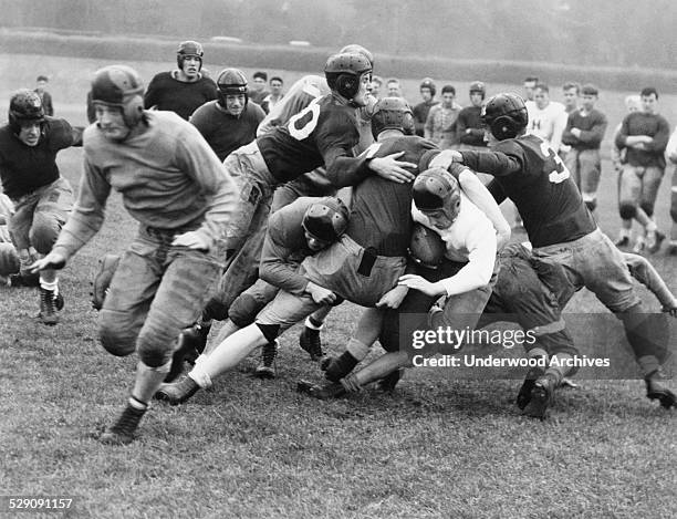 Washington High School running back Leo 'Legs' Leggett squirms through a hole in the line for a short gain, San Francisco, California, August 30,...