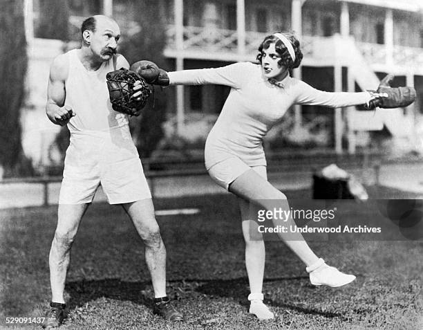 Comedian Jimmy Finlayson questions actress Martha Sleeper's choice of sporting equipment when he invites her for some preseason baseball practice,...