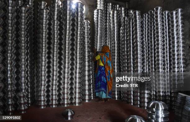 Bangladeshi labourer works in a aluminum cookware factory in Dhaka on May 8 during a strike called by Jamaat-e-Islami to protest against the death...