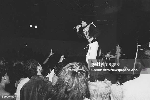 African-American bassist, songwriter and record producer Andre Cymone performing on stage, Washington DC, 1980.