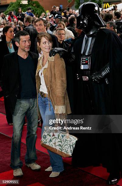 Actredd Anja Kling and her husband Jens Solf and Darth Vader pose at a cinema for the German premiere of "Star Wars - Episode III - Revenge of the...