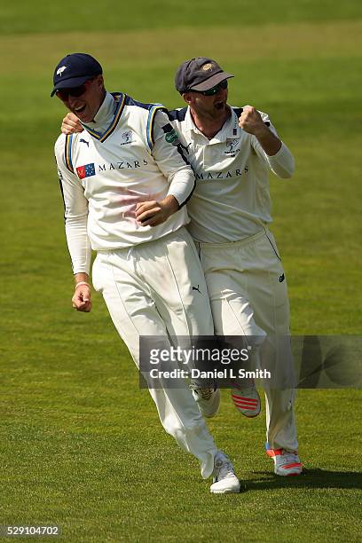 Adam Lyth of Yorkshire celebrates with Joe Root or Yorkshire after catchin the ball from Jason Roy of Surrey during the Specsavers County...
