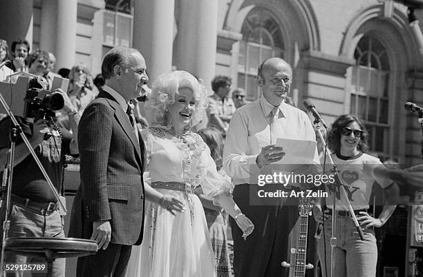 Ed Koch kissing Dolly Parton at NYC City hall after her performance; circa 1970; New York