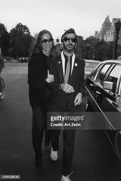 Ringo Starr with Barbara Bach, his wife walking on the street; circa 1970; New York.