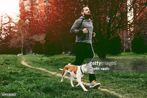 man jogging with his dog. - active lifestyle overweight stock pictures, royalty-free photos & images