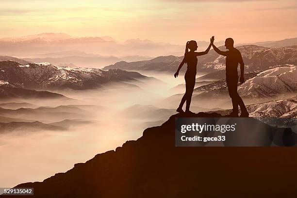 success men and woman on the mountain - reaching summit stock pictures, royalty-free photos & images