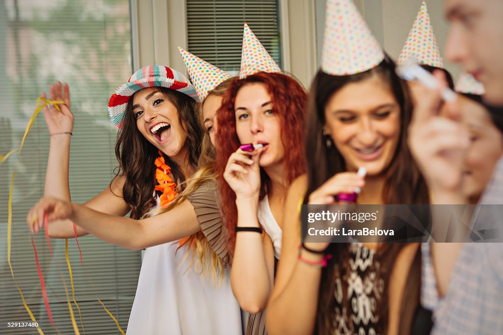 Group of young people celebrating birthday on the street