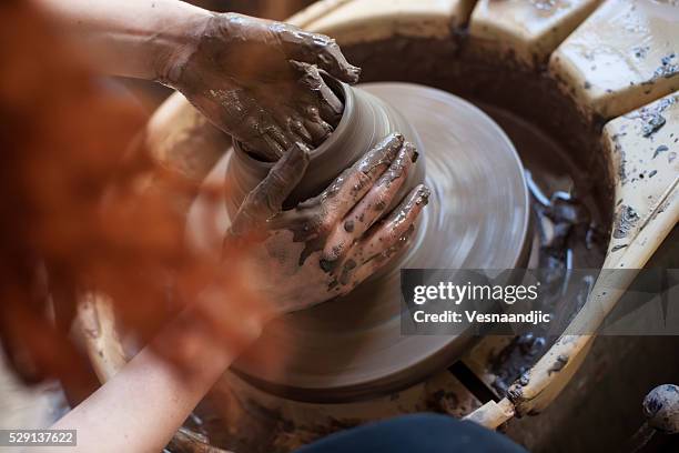 hands working on pottery wheel - pottery making stock pictures, royalty-free photos & images