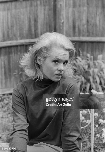 Joey Heatherton seated in a garden; circa 1970; New York.