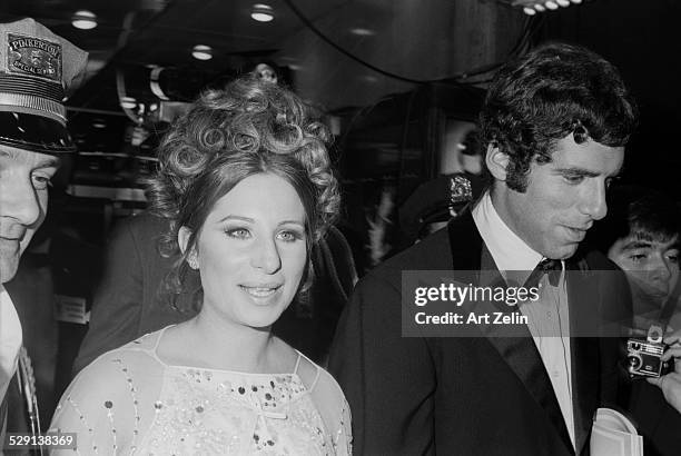 Elliott Gould with Barbra Streisand arriving at a formal event; circa 1970; New York.