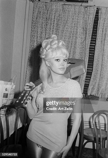 Charo wearing a beaded blouse and holding a guitar; circa 1970; New York.