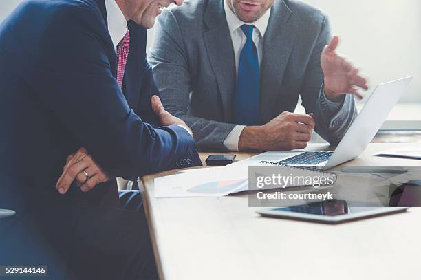 businessmen working together on a laptop. - talking close up business stockfoto's en -beelden