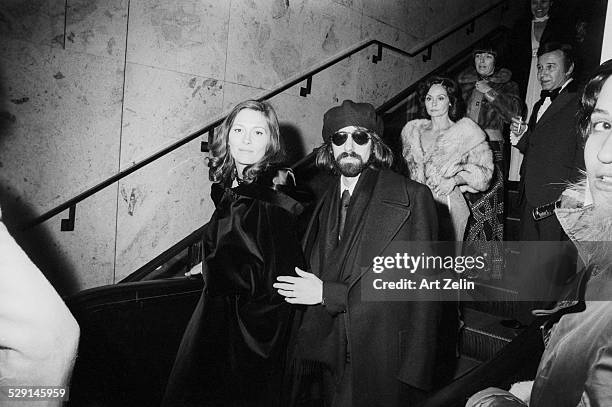 Faye Dunaway and Peter Wolf wearing formal dress leaving a formal event; circa 1970; New York.