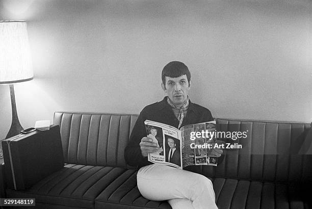 Leonard Nimoy reading a magazine waiting for interview; circa 1970; New York.