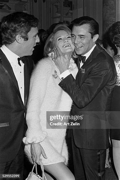 Dirk Bogarde Angie Dickinson and Burt Bacharach at a formal event; circa 1970; New York.