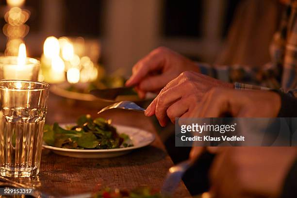 close-up of hands at candlelight dinner - dänemark gemütlich stock-fotos und bilder