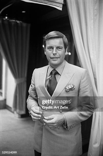 Robert Wagner holding a room key wearing a double breasted jacket at the Regency Hotel; circa 1970; New York.