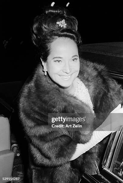 Merle Oberon wearing a fur getting into a limousine; circa 1970; New York.