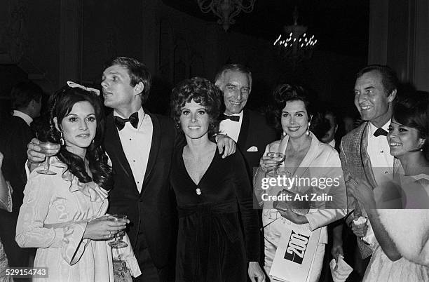 Stefanie Powers with friends wearing a velvet evening dress; circa 1970; New York.