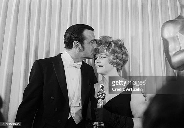 Carol Grace wife of Walter Matthau receiving a kiss and an Oscar; circa 1970; New York.