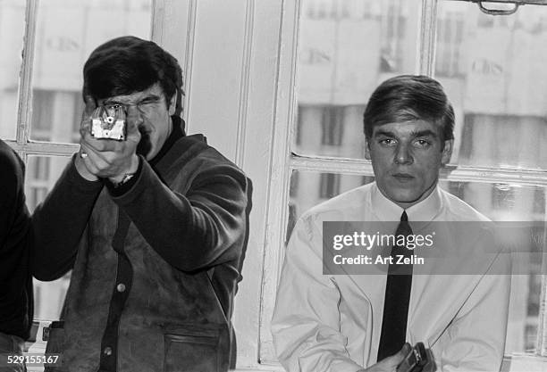 Members of the Dave Clark Five at the Warwick Hotel 1965. Person on the right is aiming an instrument at the photographer as if to shoot.; New York.