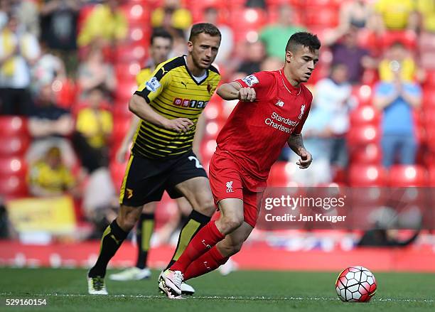 Philippe Coutinho of Liverpool holds off Almen Abdi of Watford during the Barclays Premier League match between Liverpool and Watford at Anfield on...
