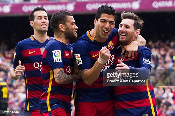 Sergio Busquets, Dani Alves and Luis Suarez celebrate with their teammate Lionel Messi after scoring the opening goal during the La Liga match...