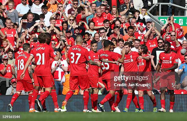 Joe Allen of Liverpool celebrates with his team mates after scoring his side's first goal during the Barclays Premier League match between Liverpool...