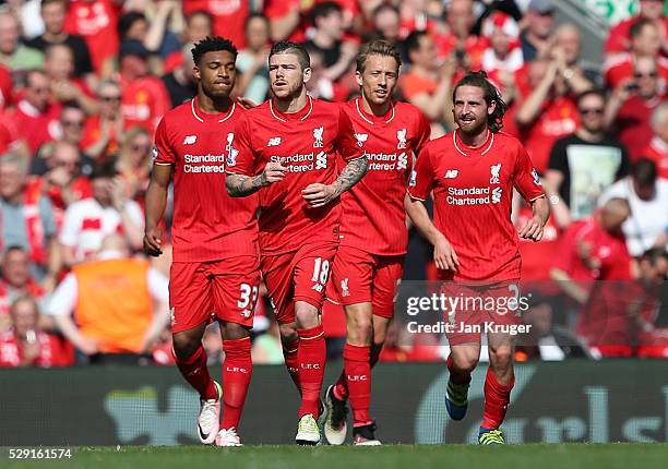Joe Allen of Liverpool celebrates with his team mates after scoring his side's first goal during the Barclays Premier League match between Liverpool...