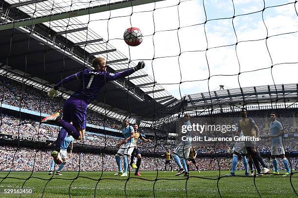 Olivier Giroud of Arsenal scores his side's first goal past Joe Hart of Manchester City during the Barclays Premier League match between Manchester...