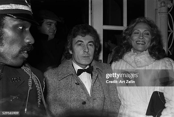 Faye Dunaway wearing a white fur with Alan Bates; circa 1980; New York.