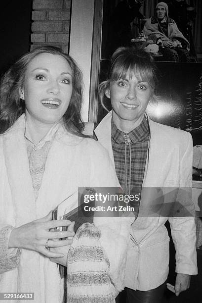 Olivia Newton-John with Jane Seymour outside a theater, New York, circa 1983.