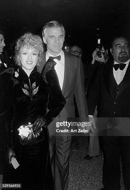 Steve Martin with Bernadette Peters outside attending a formal event; circa 1980; New York.