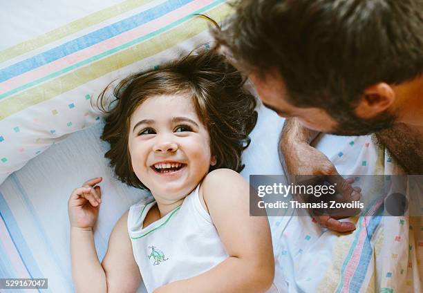 Small girl playing with her father