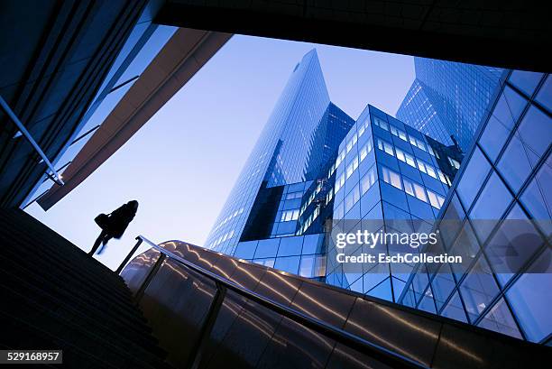 businesswoman at stairs business district in paris - building top stock-fotos und bilder