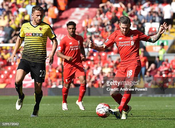Alberto Moreno of Liverpool competes with Almen Abdi of Watford during the Barclays Premier League match between Liverpool and Watford at Anfield on...